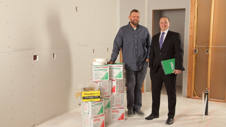 Brandon McFerren of Kyco Services and Bank of Utah's Steven Drakulich stand in an under-construction townhome