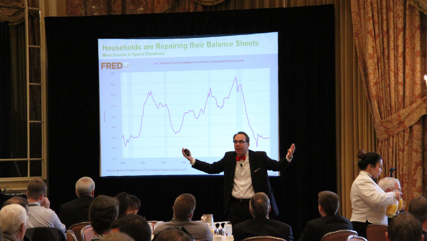 Elliott Eisenberg giving presentation if front of crowd and Bank of Utah 2016 Annual Economic Outlook.